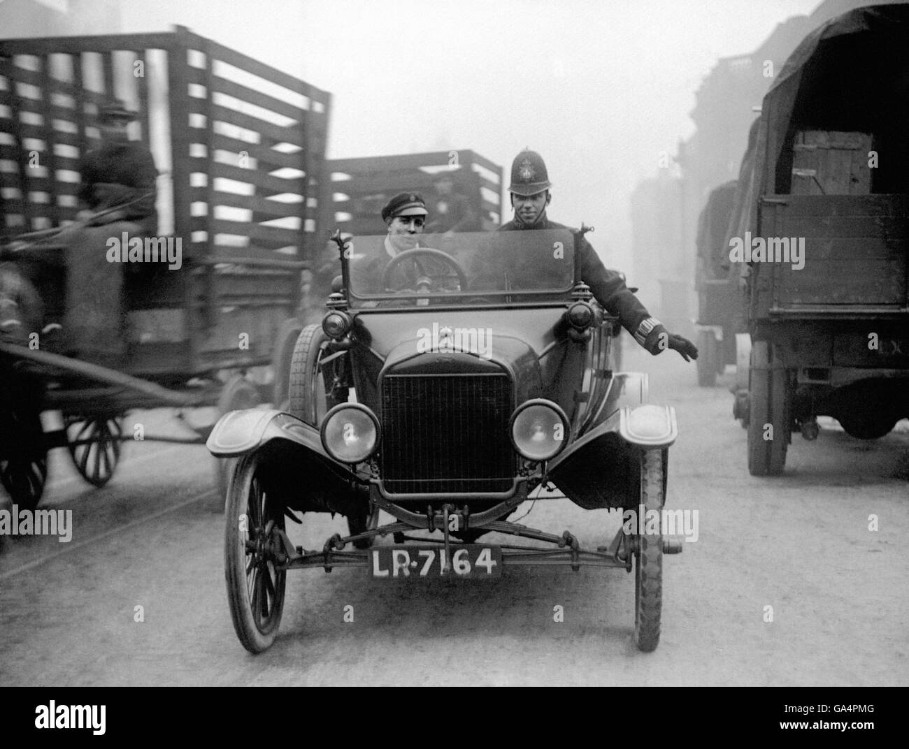 Police use a Ford Model T car to regulate slow moving traffic in the East  End of London Stock Photo - Alamy