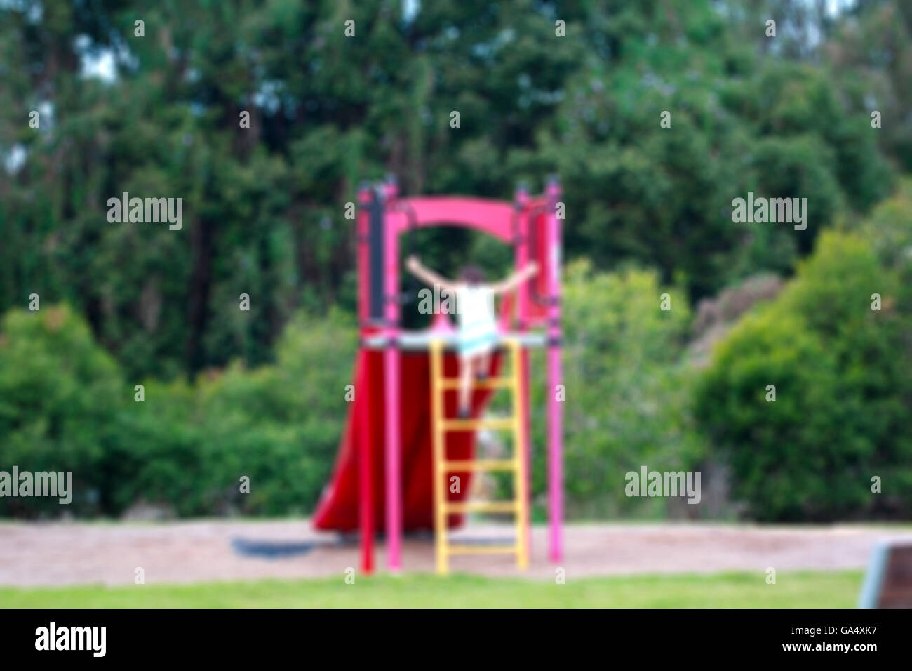 Abstract blur children playground in city park background in sun Stock Photo