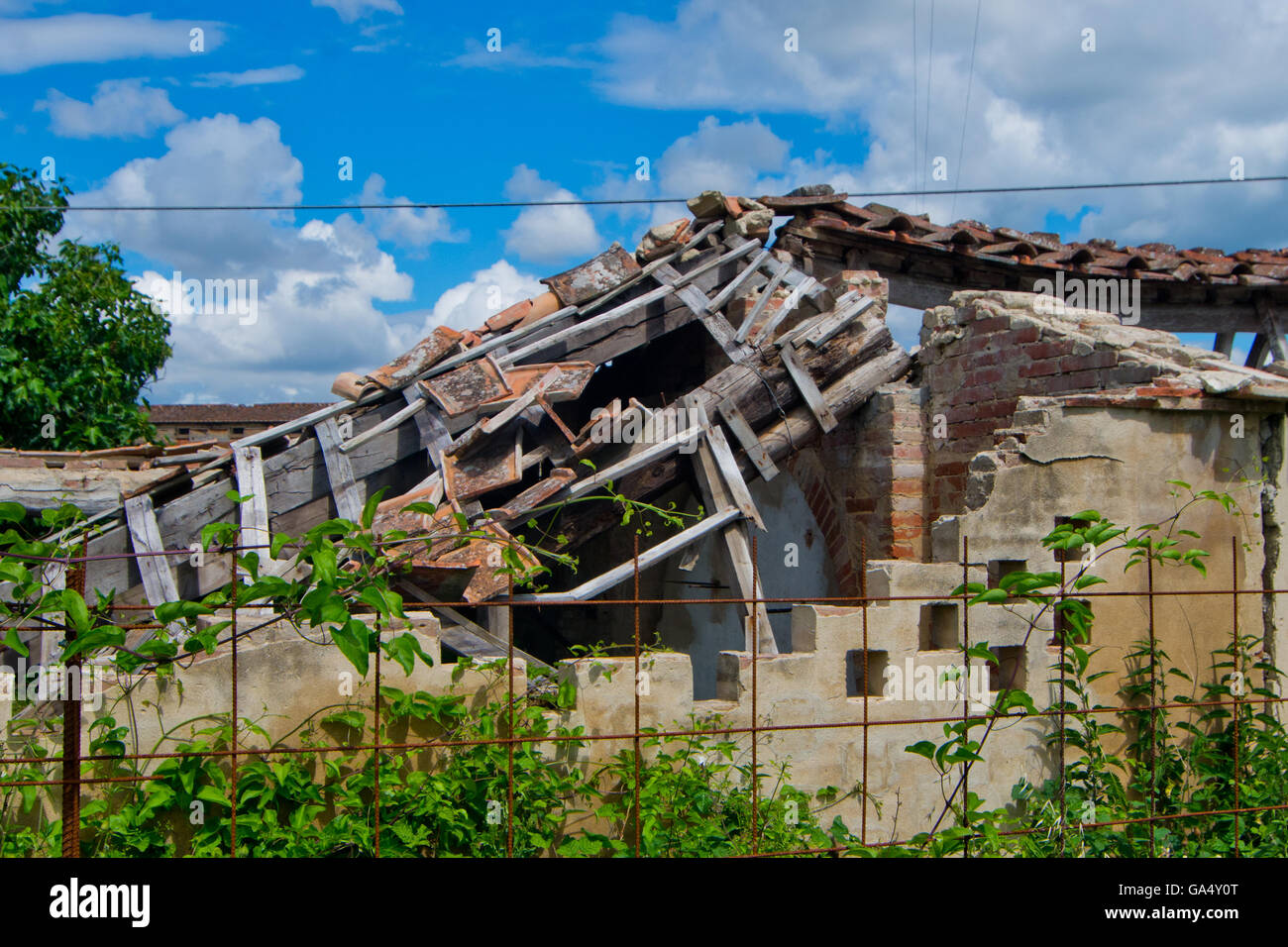 roof collapsed and destroyed of an old run down building Stock Photo