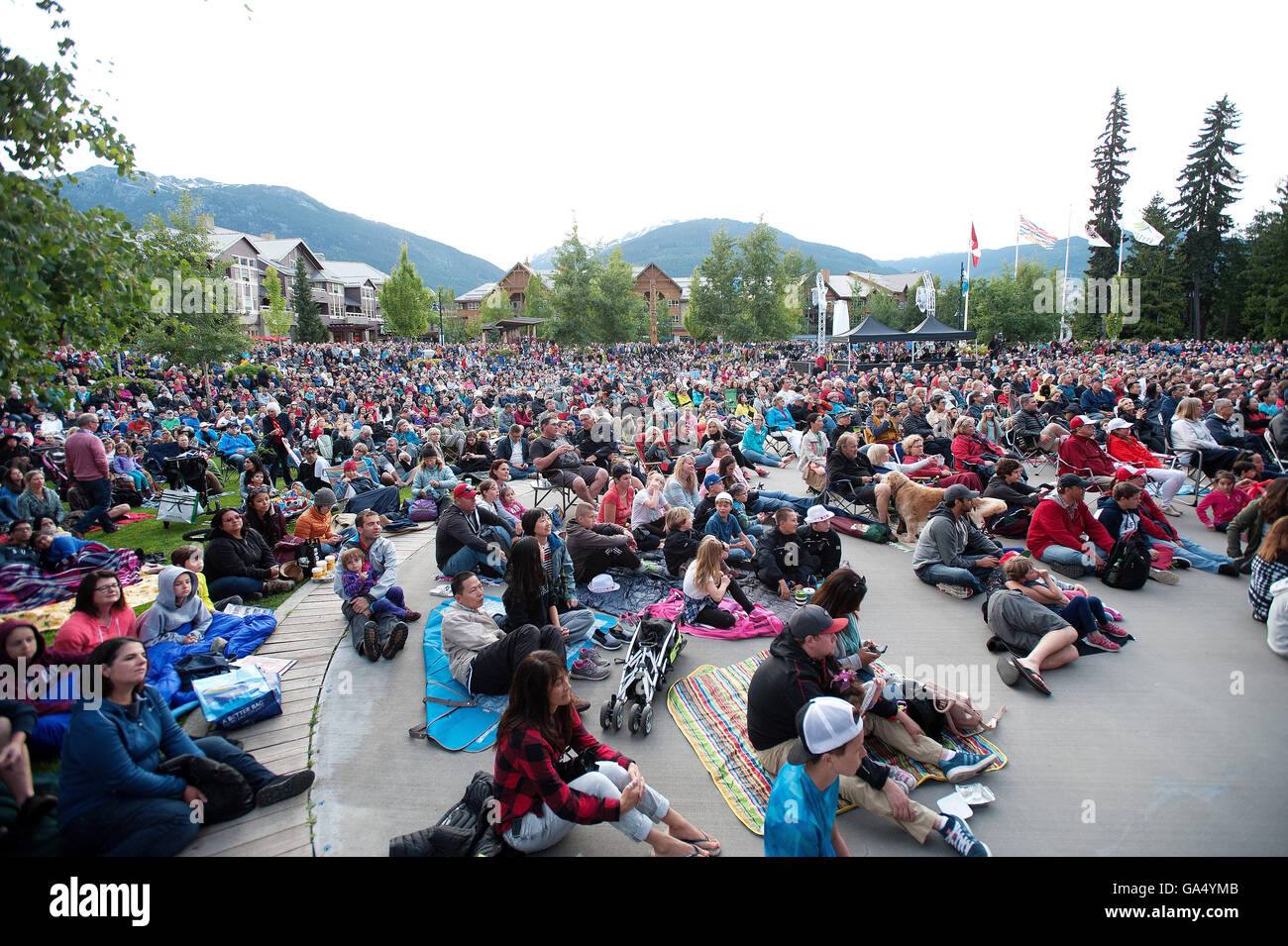 Huge crowds watch the Vancouver Symphony Orchestra during a Canada Day concert at the Whistler Olympic Plaza.  Friday, July 1, 2 Stock Photo