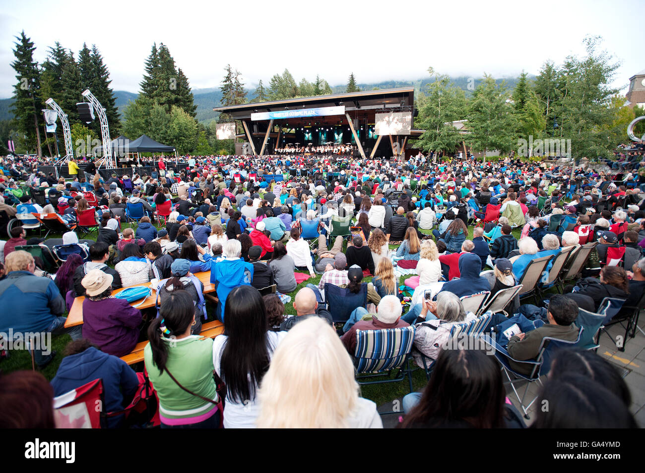 Huge crowds watch the Vancouver Symphony Orchestra during a Canada Day concert at the Whistler Olympic Plaza.  Friday, July 1, 2 Stock Photo
