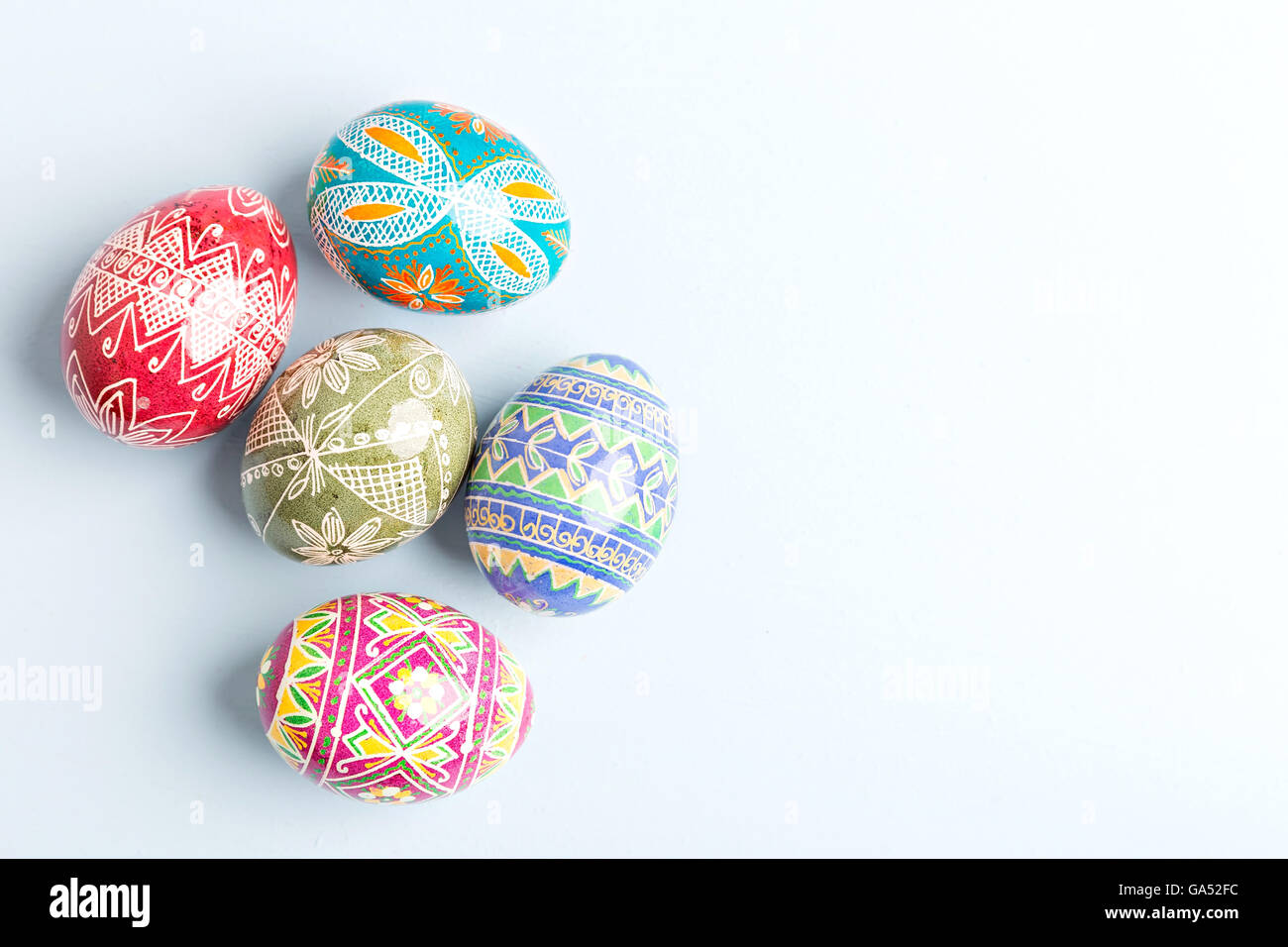 colorful shiny easter eggs on blue background Stock Photo