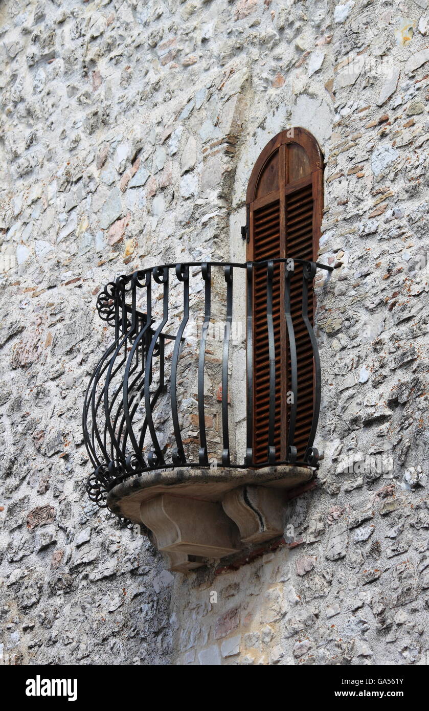 Medieval window and balcony with shutters closed Stock Photo