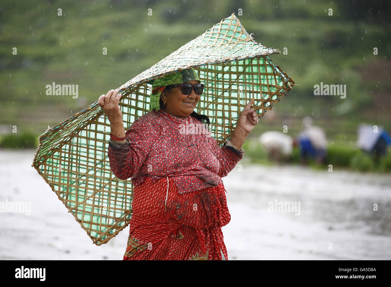 Lalitpur, Nepal. 3rd July, 2016. A Nepalese farmer wearing a