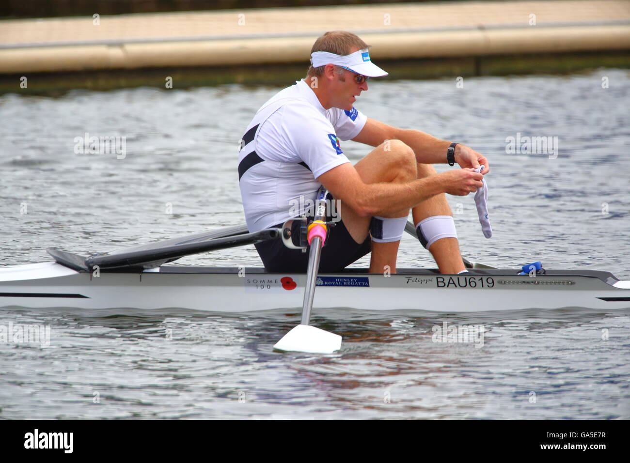 Rowers from all over the world came to the annual Henley Royal Regatta 2016. Drysdale adjusts his socks before the race. Stock Photo
