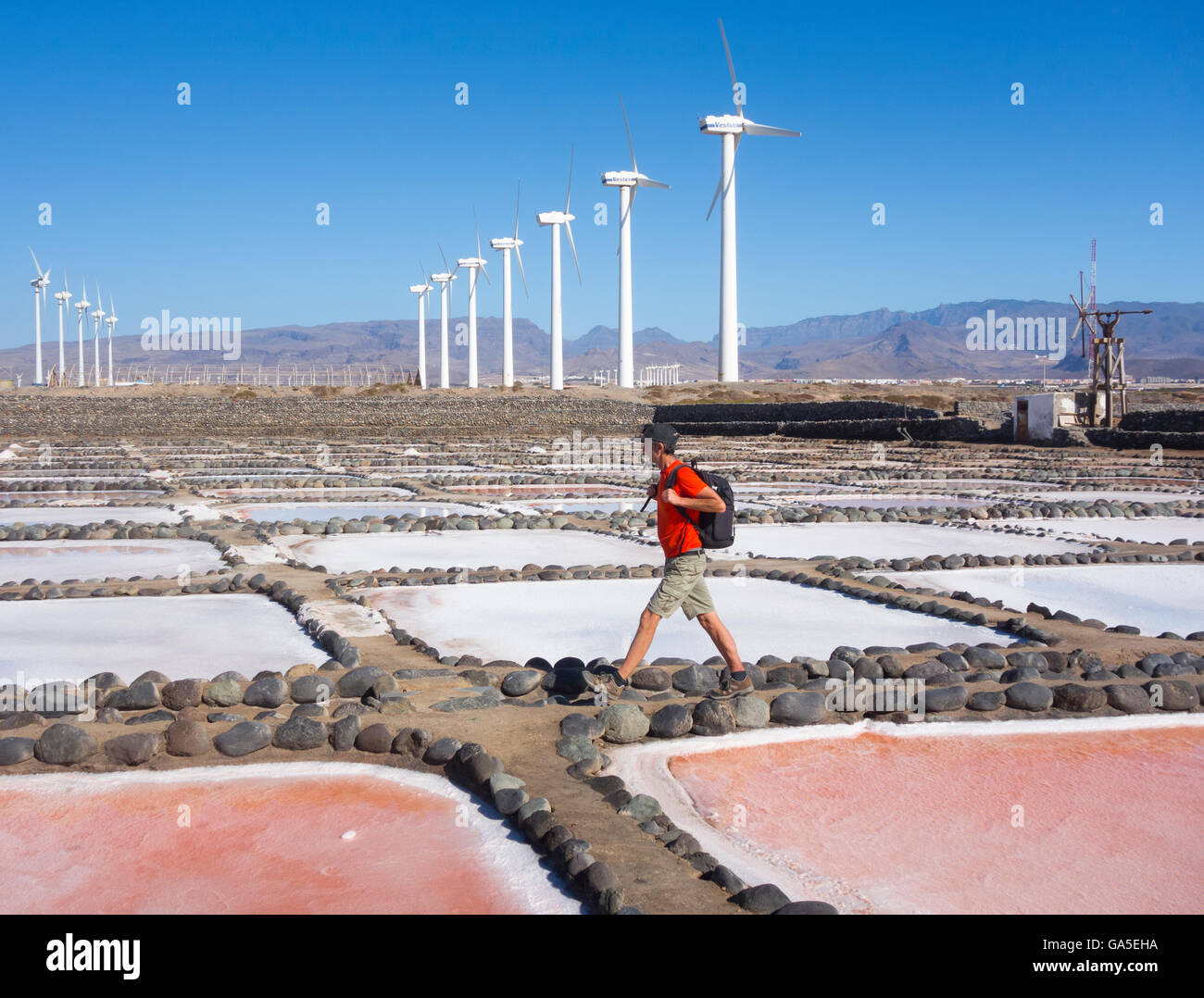 Pozo, Gran Canaria, Canary Islands, Spain, 3rd July 2016. Weather: A hiker walks through saltworks on the east coast of Gran Canaria under a cloudless sky on a glorious Sunday in the Canary Islands Credit:  Alan Dawson News/Alamy Live News Stock Photo