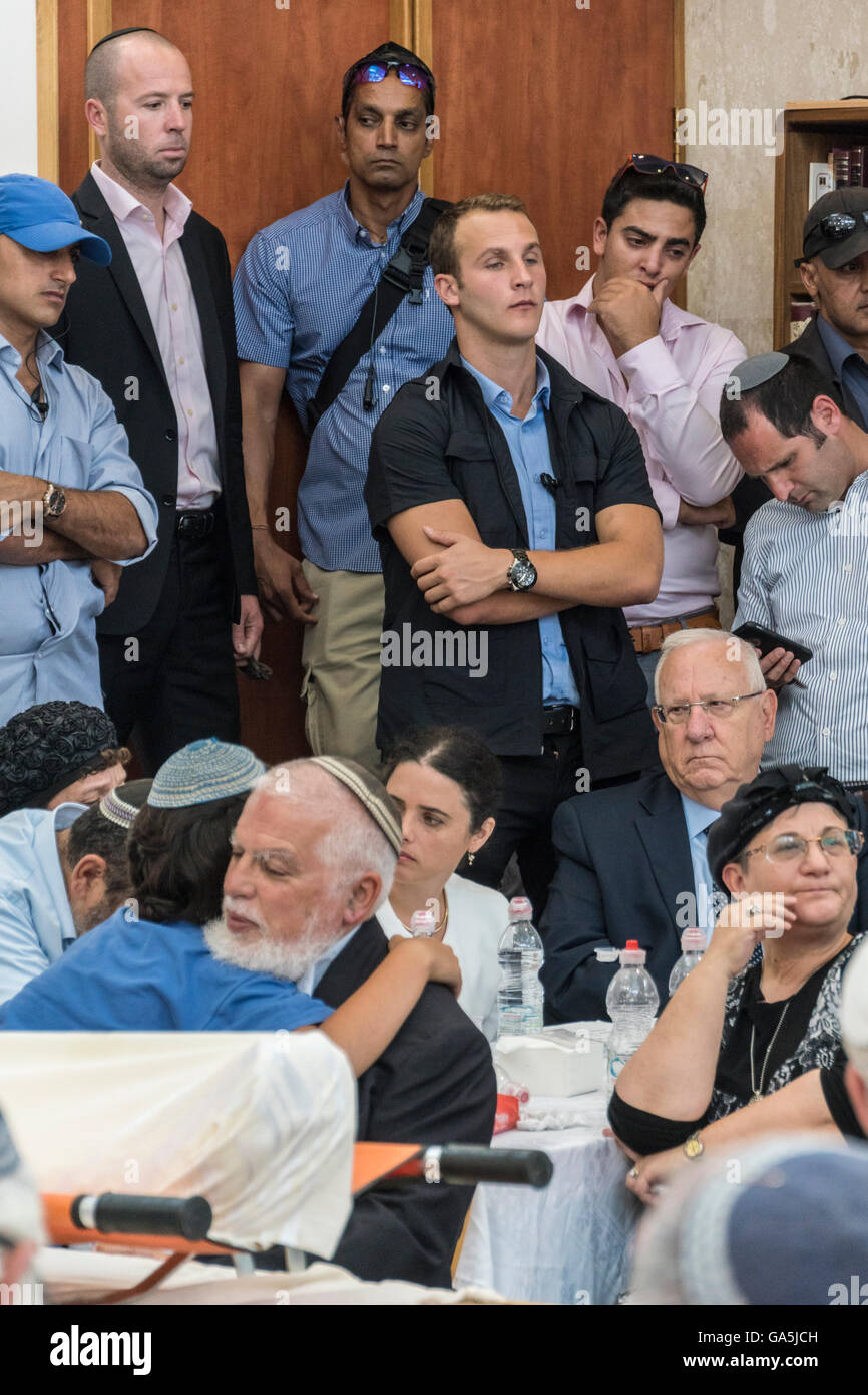 Israel. 3rd July, 2016. Rabbi Benjamin Klemanson, head of the Jewish Religious shcool ('Yeshiva') in Otniel, hugs his son behind the shawl-covered body of Klemanson's brother-in-law Michael Mark, who was  killed by palestinian terrorists who shot at his car. Mark's wife was seriously wounded as were two of his kids. relative of Mark. Behind Klemanson are, Left to Right: Israeli Justice minister Ayelet Shaked, Israeli President Reuven 'Ruby' Rivlin, Himself a  distant reative of Mark, and Yocheved Klemanson, Mark's sister. Credit:  Yagil Henkin/Alamy Live News Stock Photo