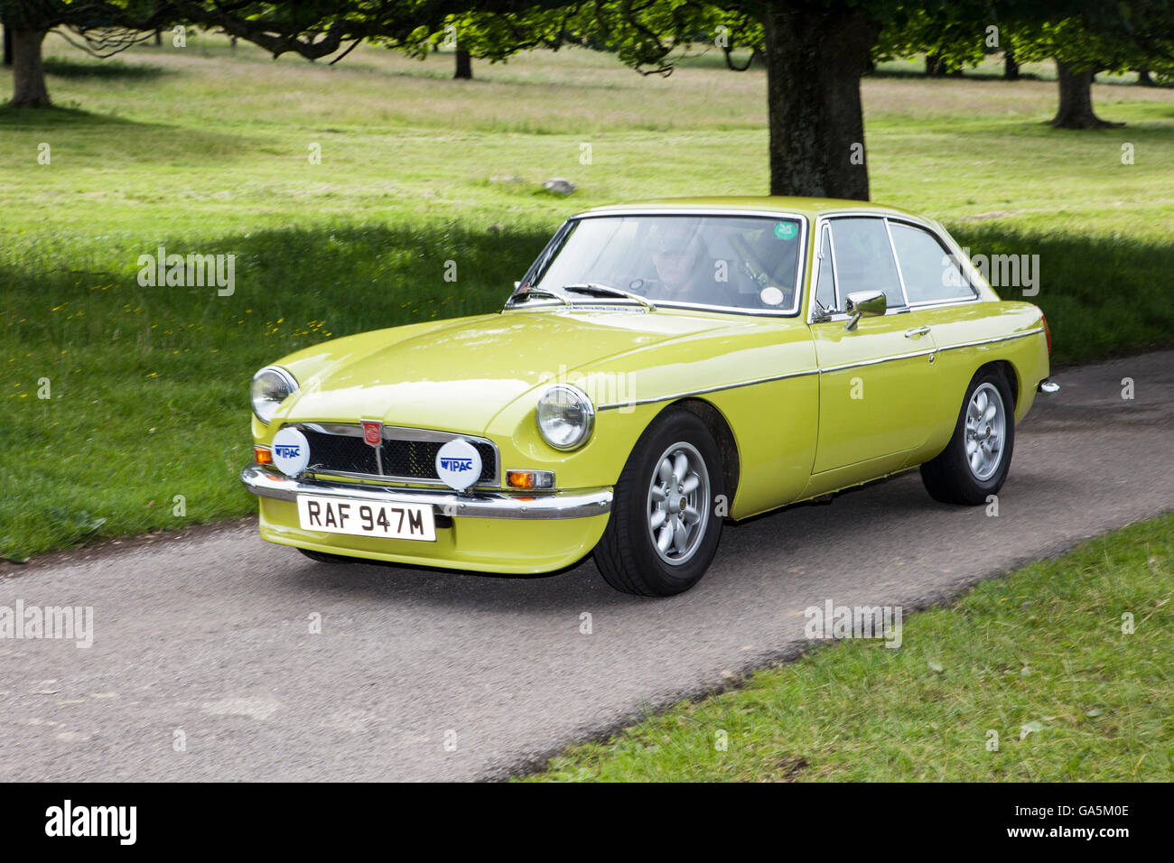 1974 MG B GT at Leighton Hall Classic Car Rally, Carnforth, Lancashire, UK.  3rd July, 2016.  The annual classic car rally takes place at the magnificent Leighton Hall in Carnforth in Lancashire.   1974 yellow MGB GT three-door 2+2 coupé; British classic sports cars MG's  The Leighton Castle spectator event drew thousands of visitors to this scenic part of the country on the north west coast of England.  Credit:  Cernan Elias/Alamy Live News Stock Photo