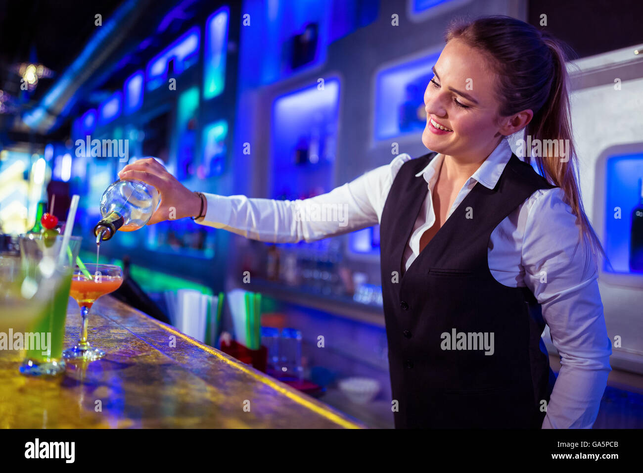 Beautiful bartender pouring drink in glass Stock Photo Alamy