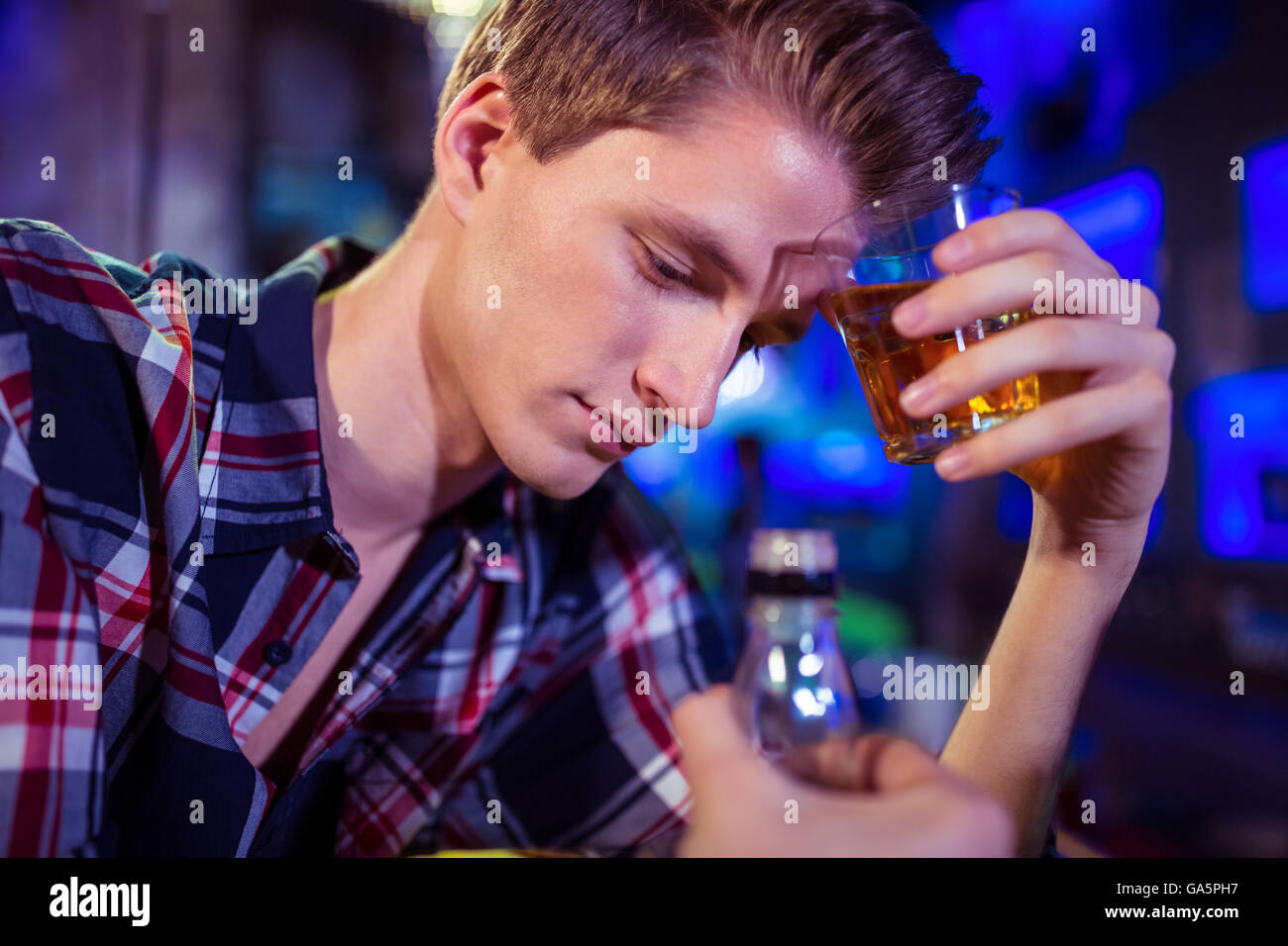 Sad man holding whiskey glass Stock Photo