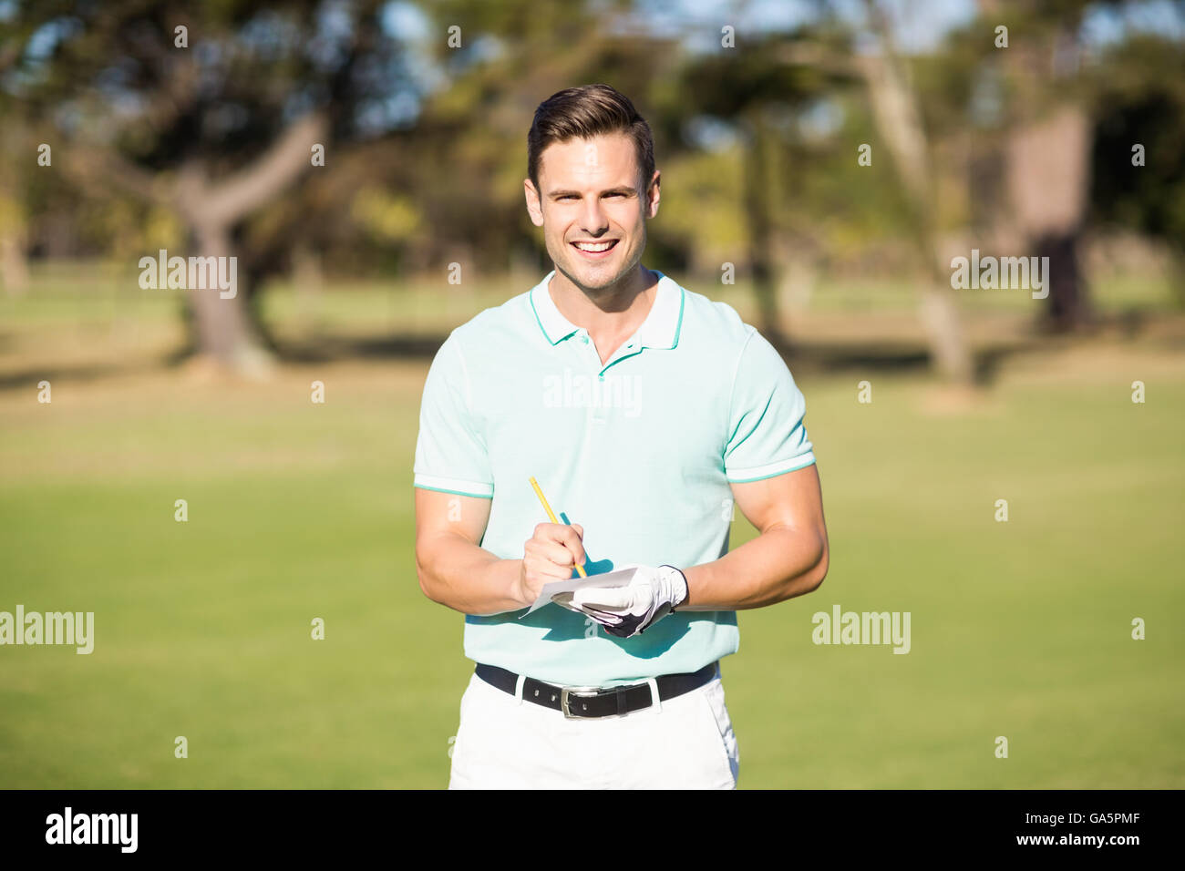 Portrait of smiling golfer with score card Stock Photo