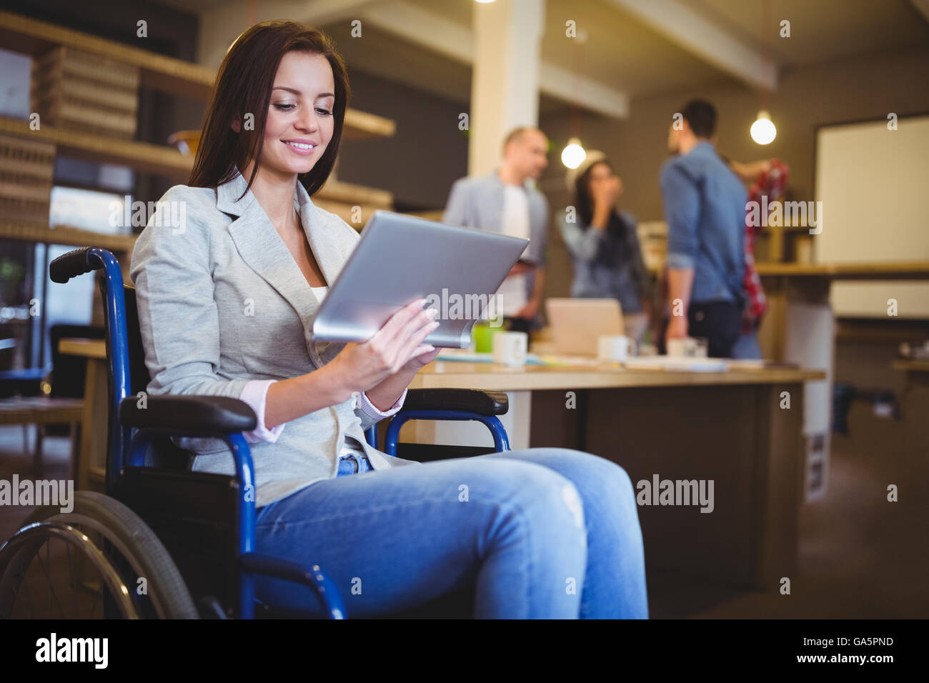 Disabled young businesswoman using digital tablet Stock Photo