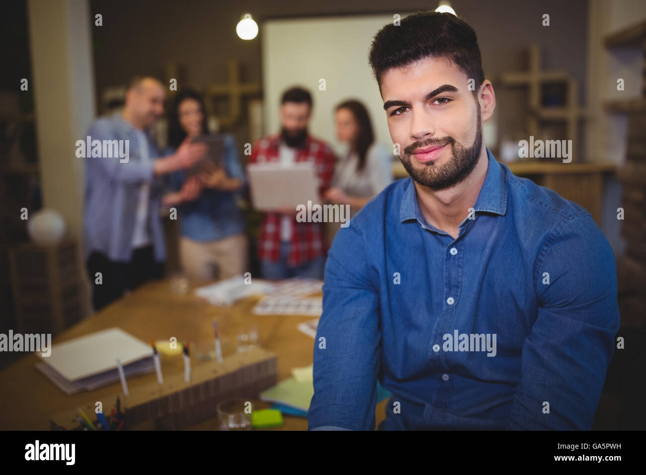 Confident young businessman in creative office Stock Photo