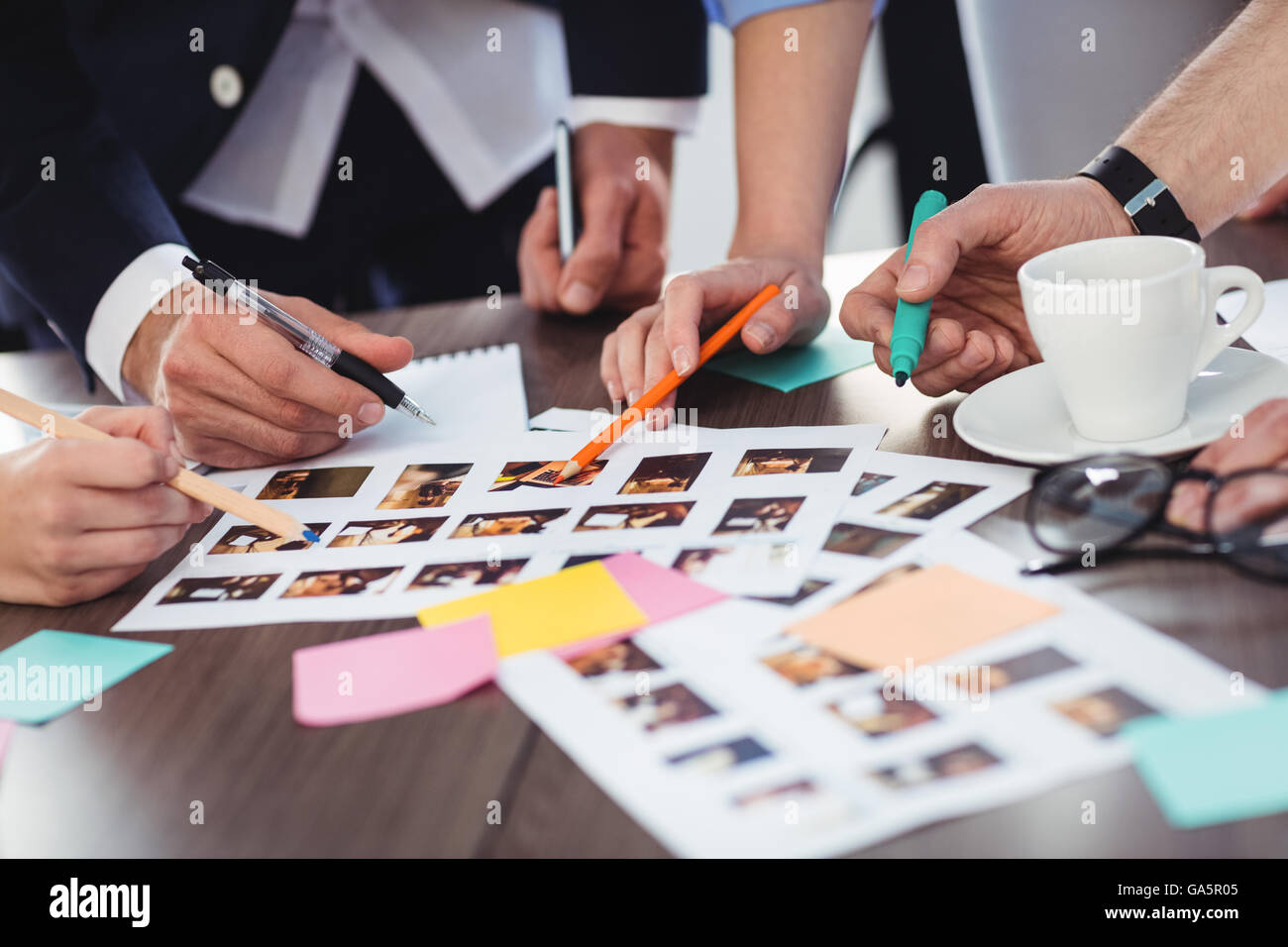 Cropped image of photo editors with documents Stock Photo