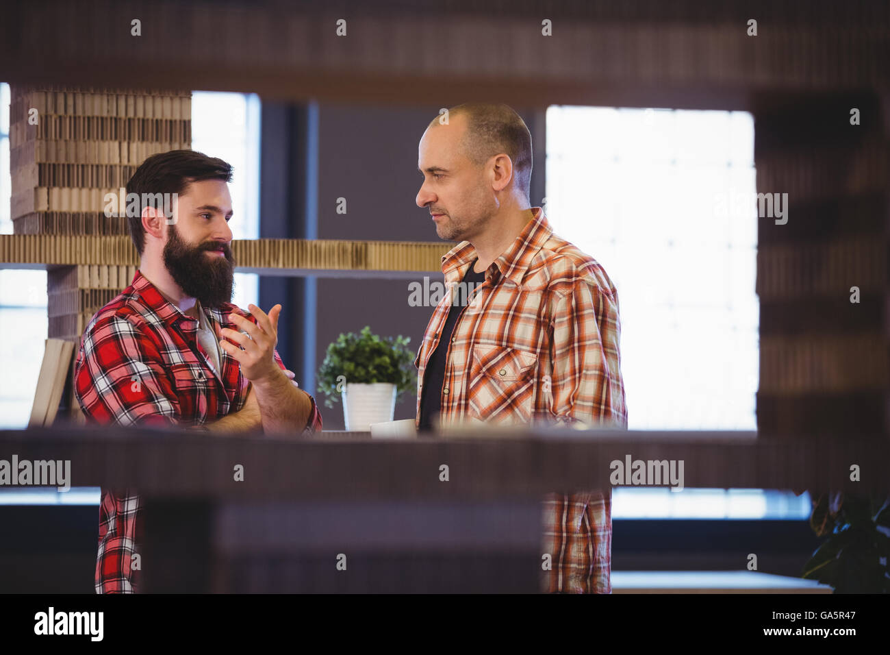 Male colleagues discussing in creative office Stock Photo