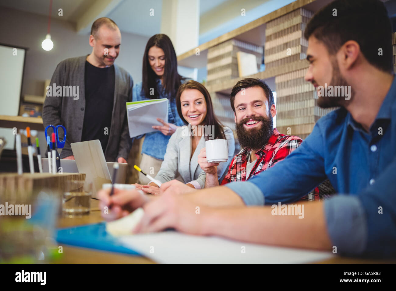 Business people smiling during meeting Stock Photo