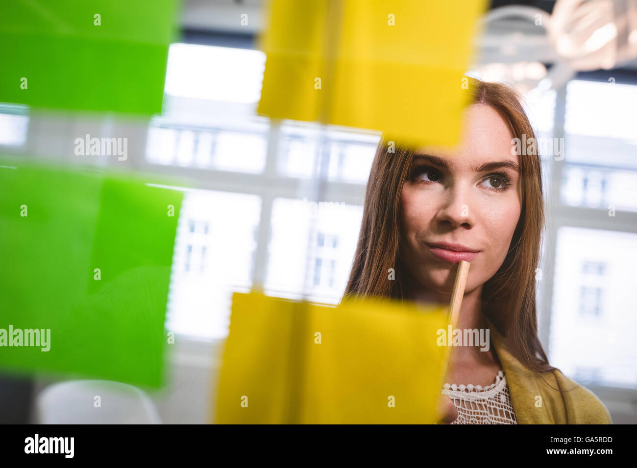 Businesswoman looking at sticky notes Stock Photo - Alamy
