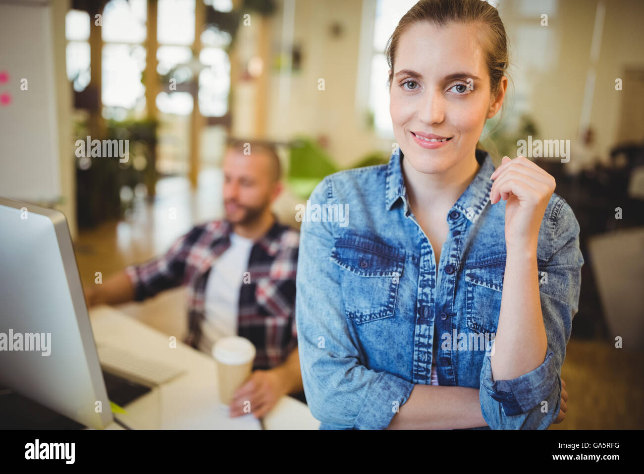 Businesswoman with male colleague in office Stock Photo