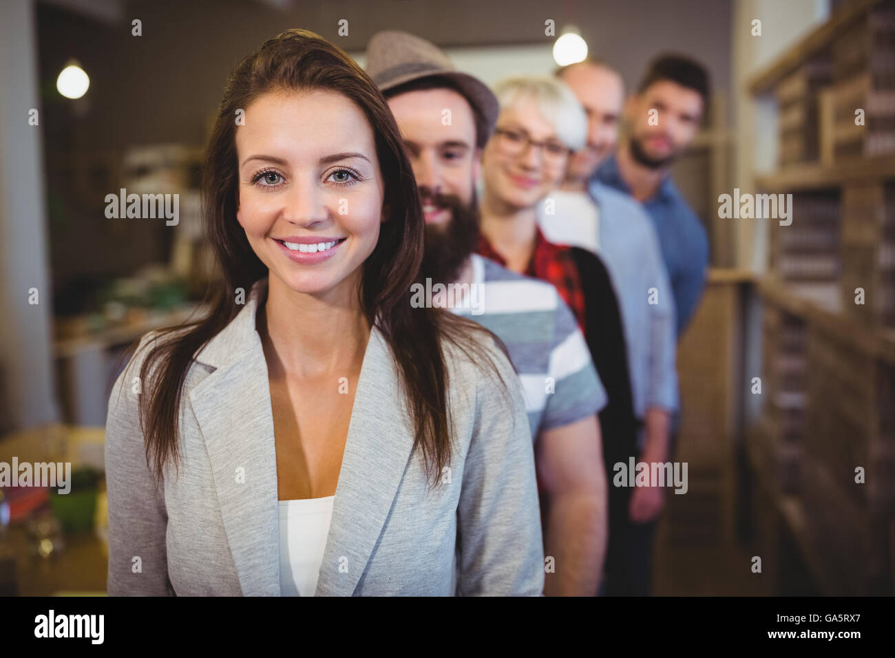 Confident businesswoman with colleagues standing in row Stock Photo