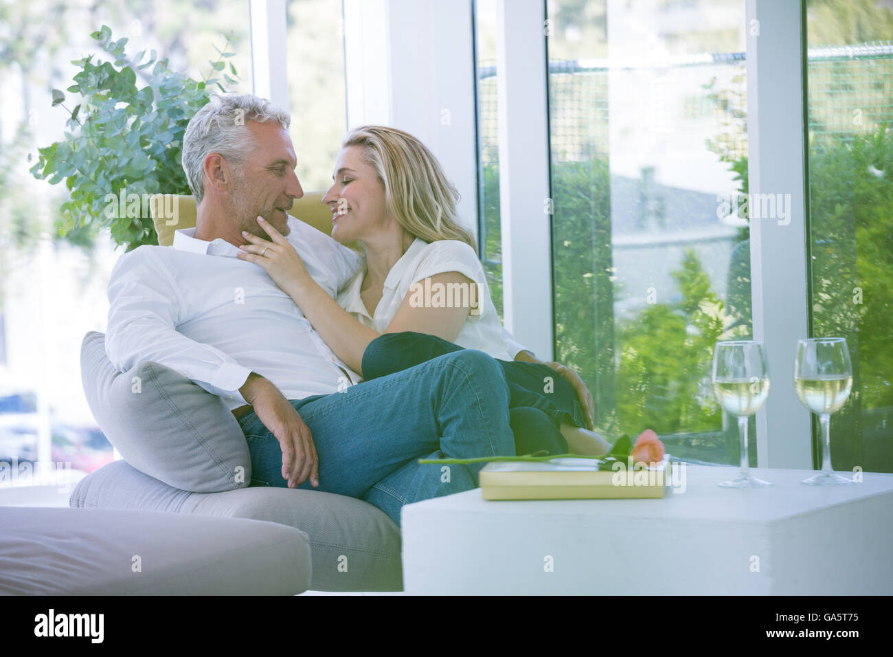 Romantic mature couple sitting on armchair Stock Photo