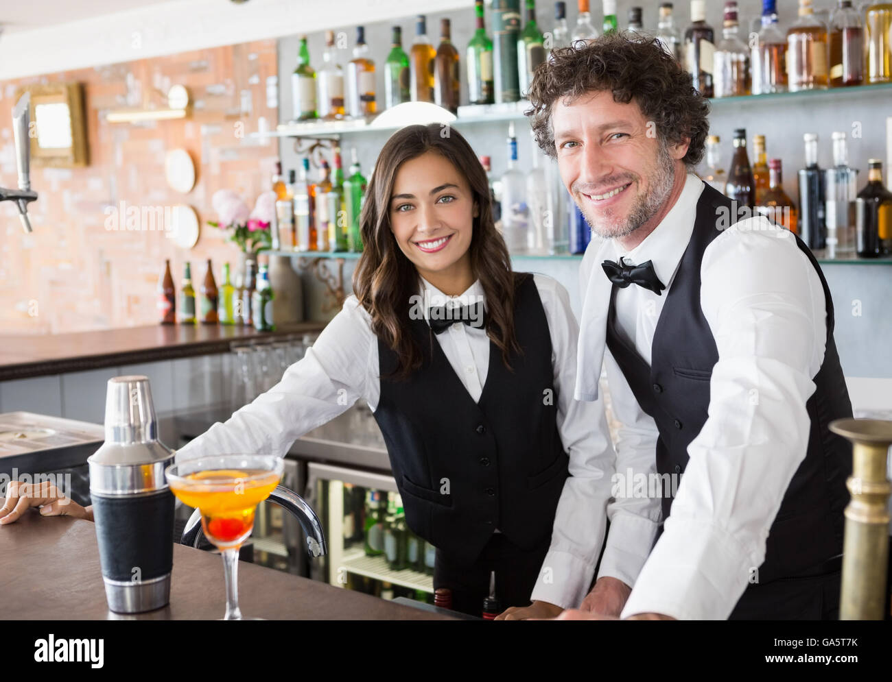 Portrait of waiter and waitress smiling Stock Photo Alamy