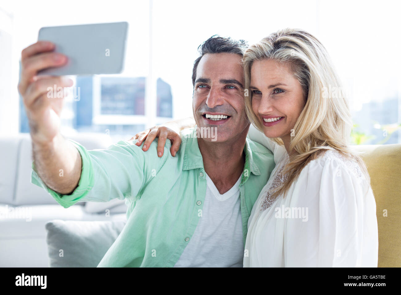 Couple taking selfie at home Stock Photo - Alamy