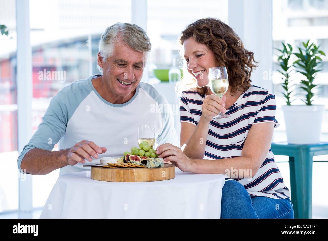 Mature couple sitting at restaurant Stock Photo
