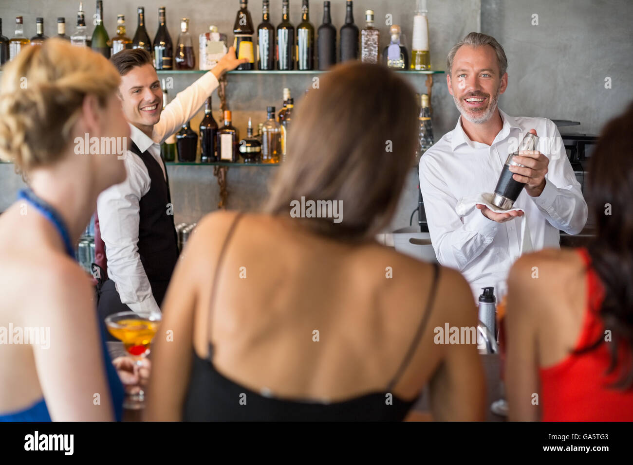 Female friends ordering drinks Stock Photo