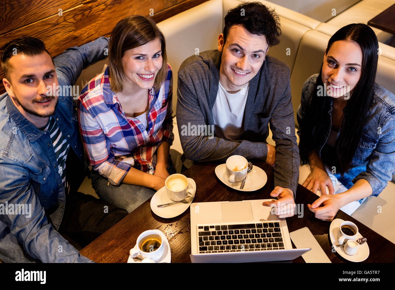 High angle view friends using laptop at restaurant Stock Photo