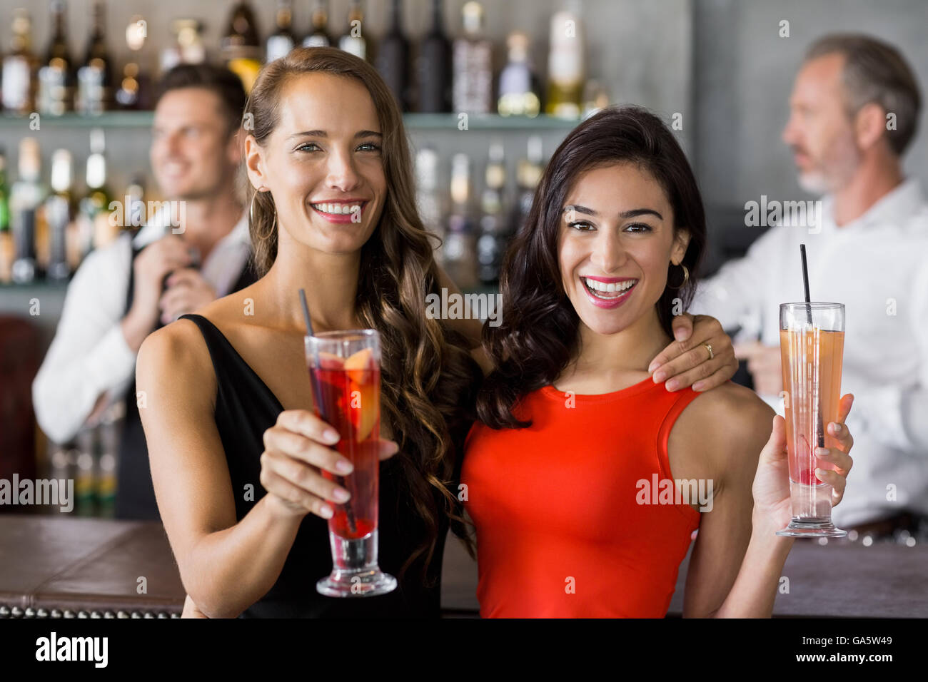 Two beautiful women holding cocktail glass Stock Photo Alamy