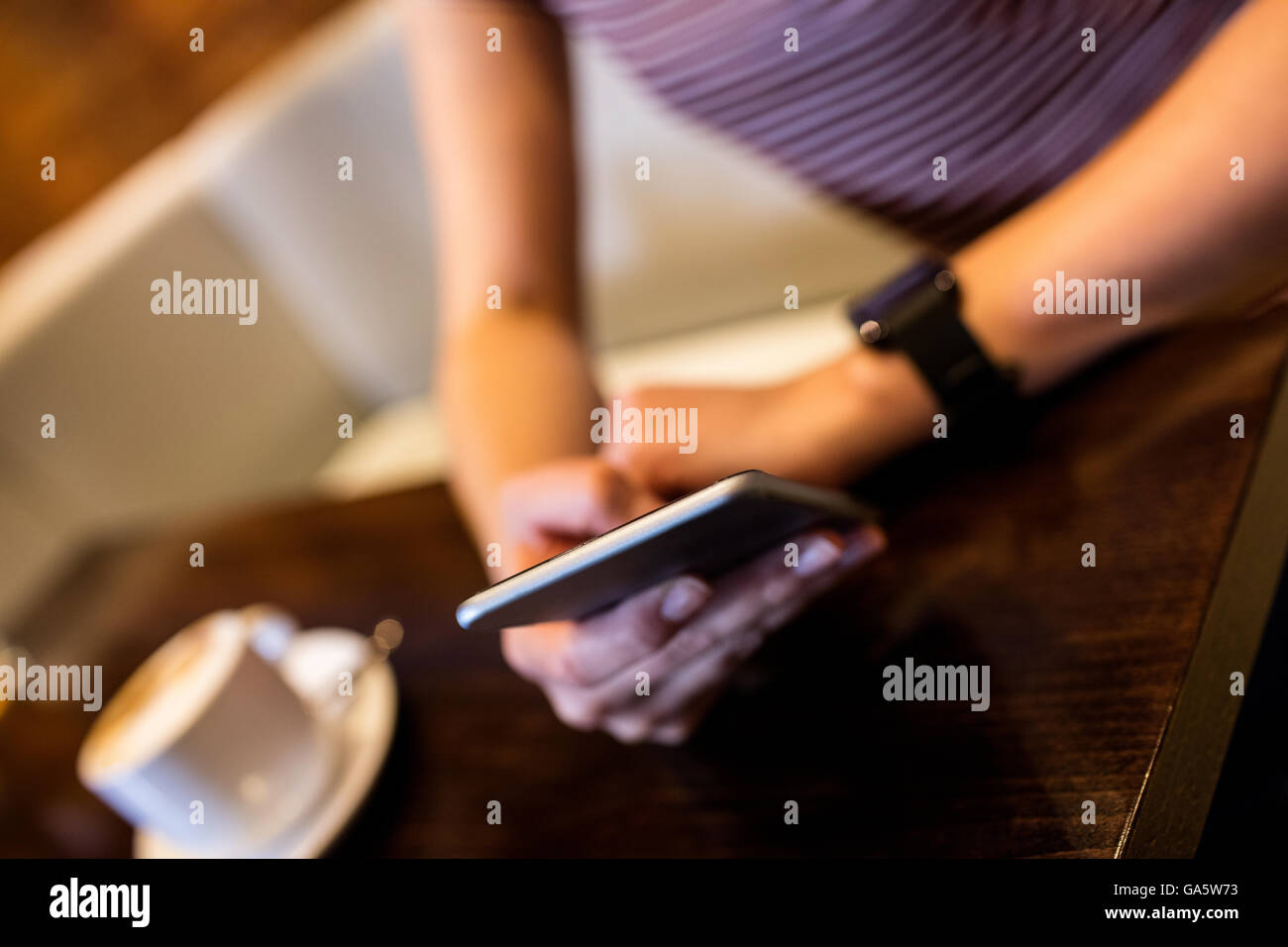 Midsection of woman using cellphone Stock Photo