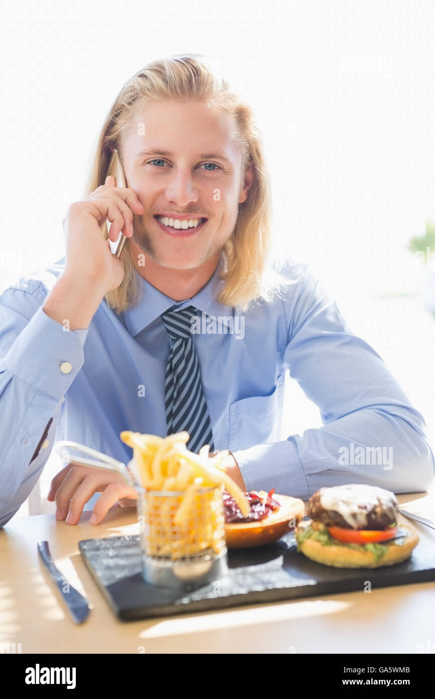 Man talking on mobile phone while having breakfast Stock Photo