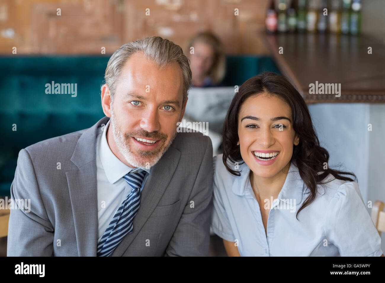 Business colleague smiling in restaurant Stock Photo