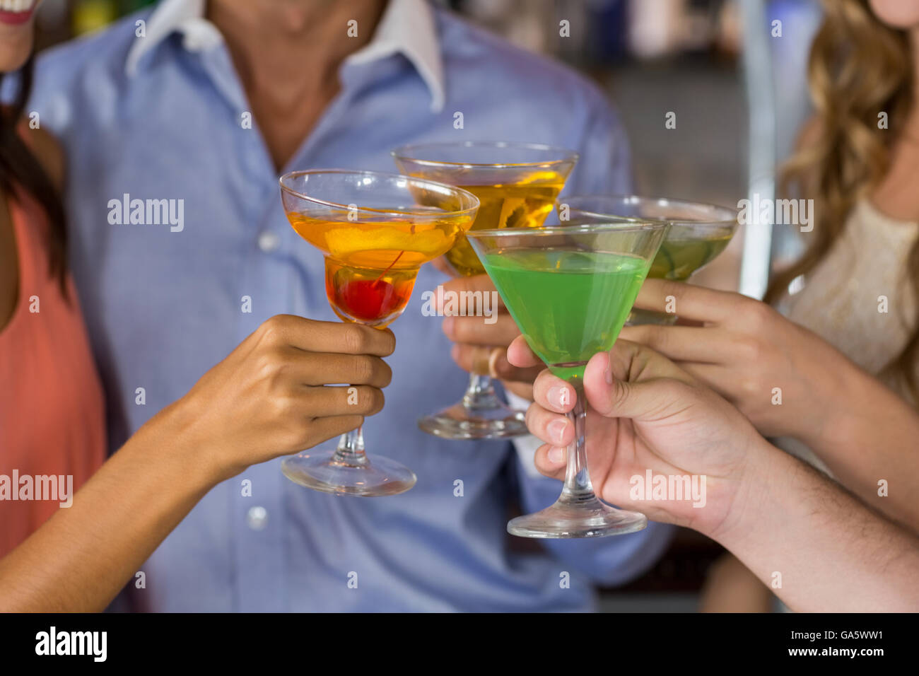 Friends toasting martini and cocktail glass Stock Photo