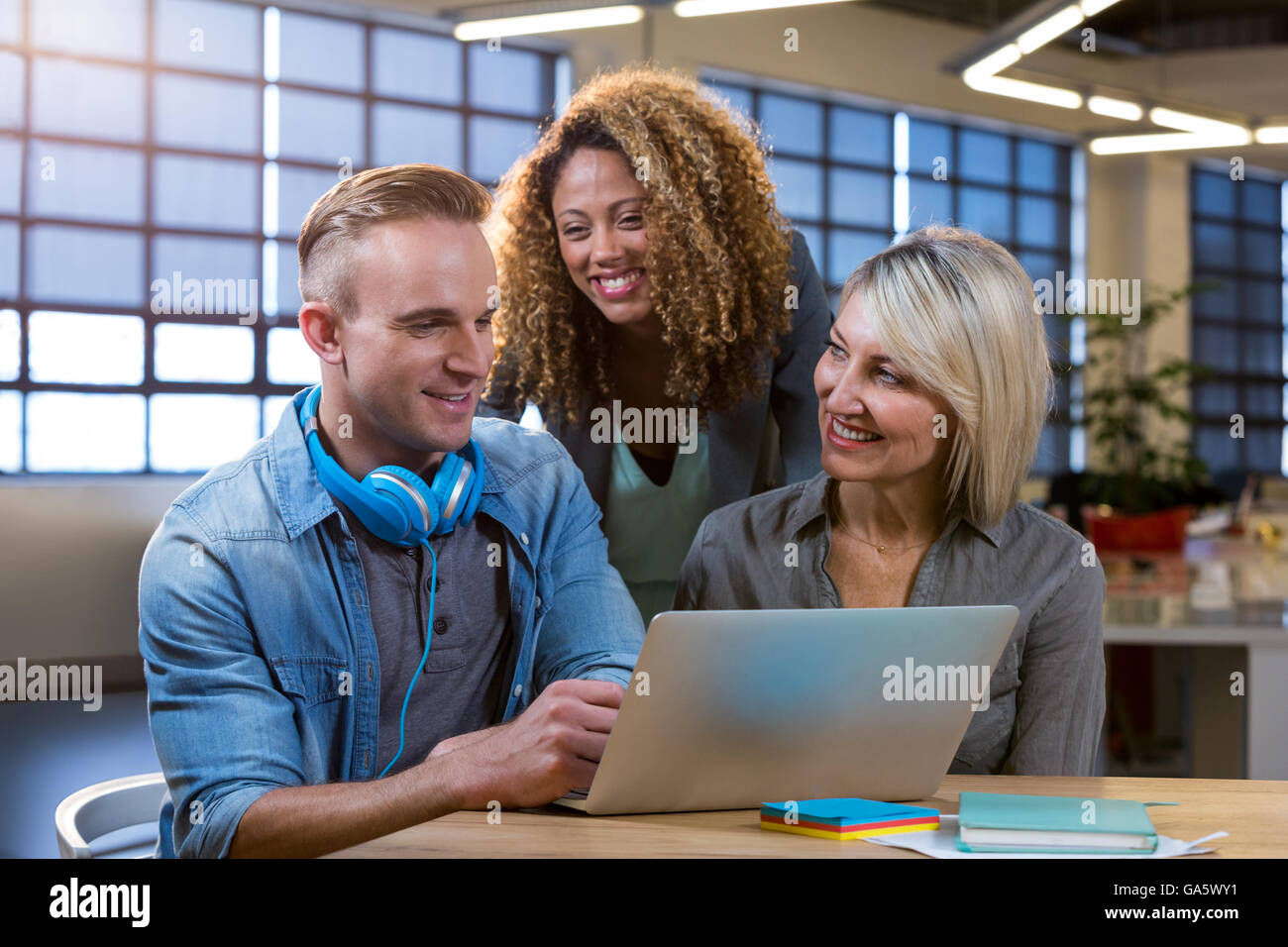 Business people discussing over laptop Stock Photo
