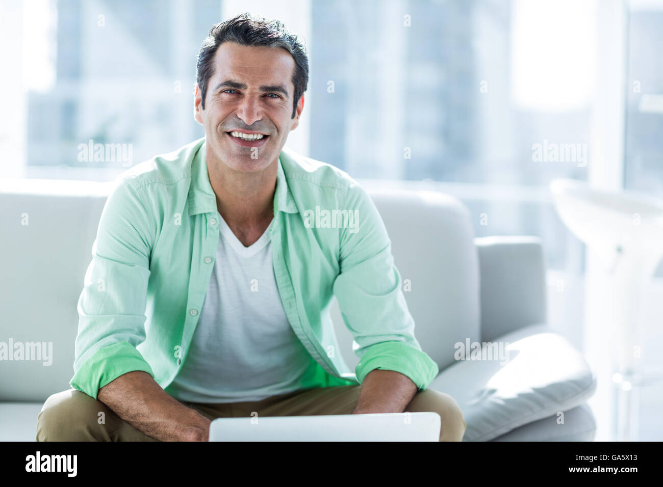 Man using laptop while sitting at home Stock Photo
