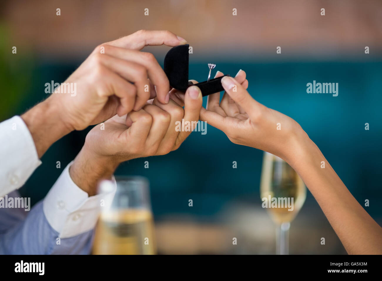 Man proposing to woman offering engagement ring Stock Photo