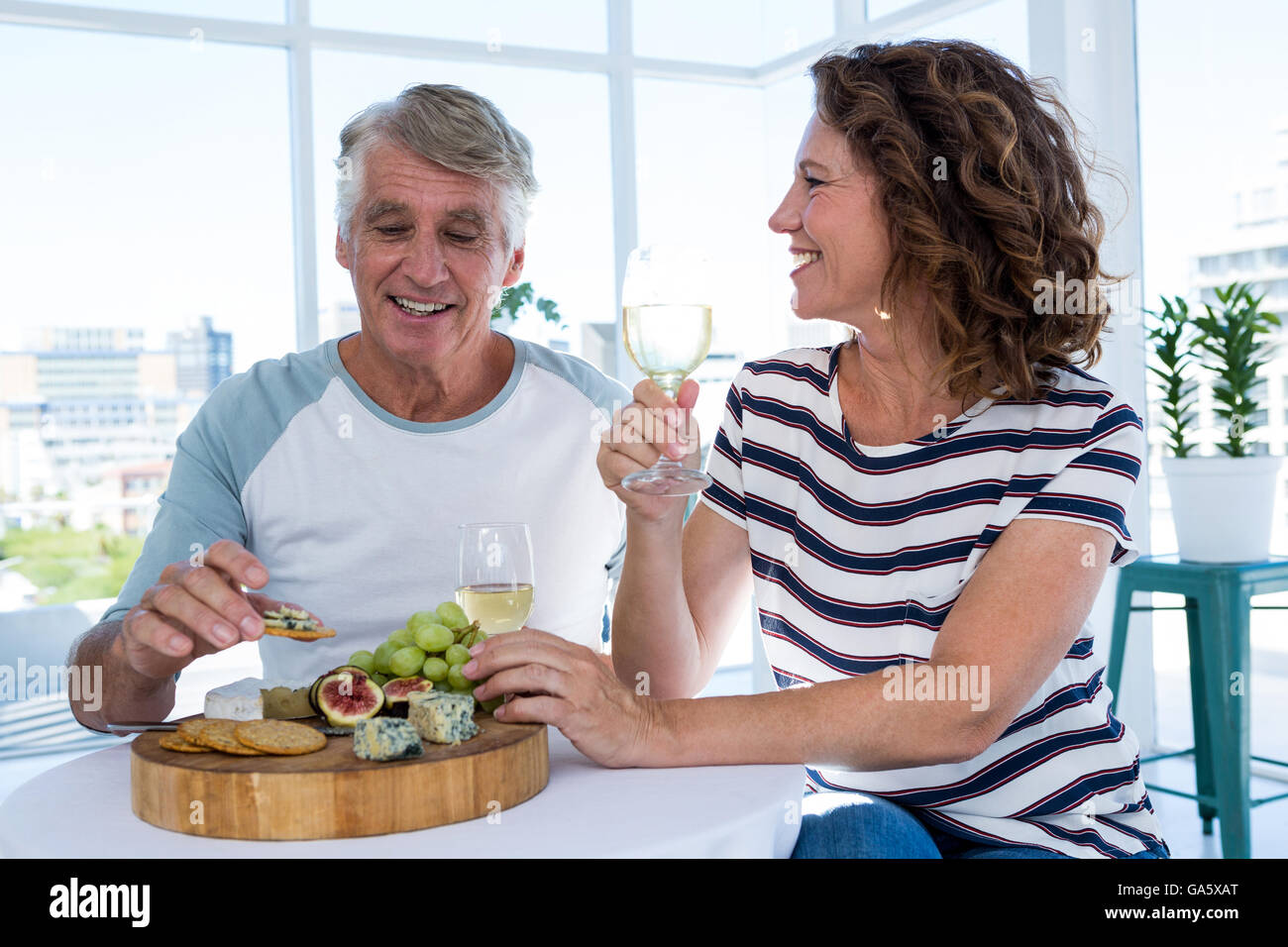 Happy mature couple sitting at restaurant Stock Photo