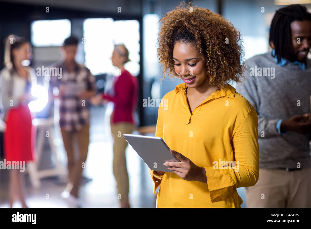 Woman using digital tablet in office Stock Photo