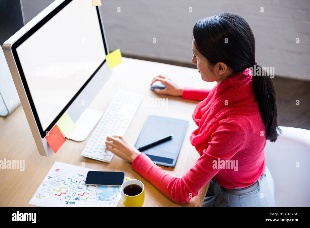 Young businesswoman working on computer in office Stock Photo - Alamy