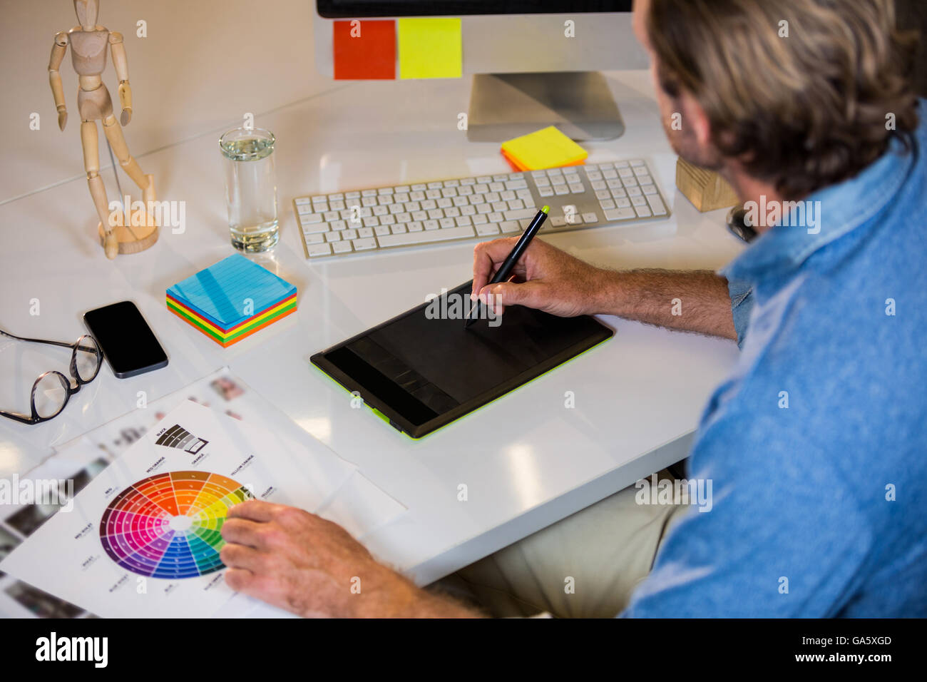 Person Using Graphics Tablet Businessman using graphics tablet at desk Stock Photo - Alamy