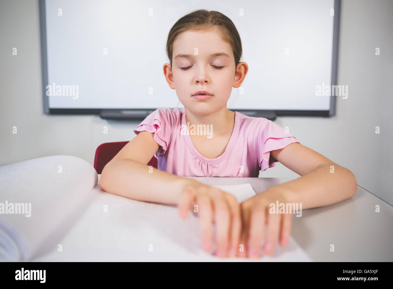 Schoolgirl reading a braille book in classroom Stock Photo Alamy