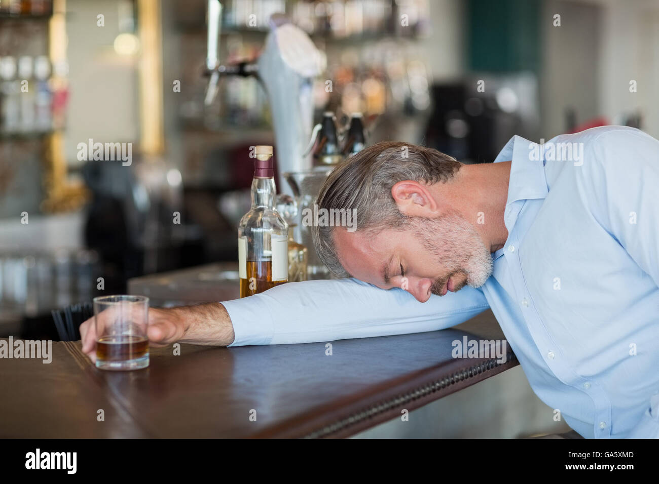 Happy Man Holding Drinking Glasses In The Kitchen High-Res Stock