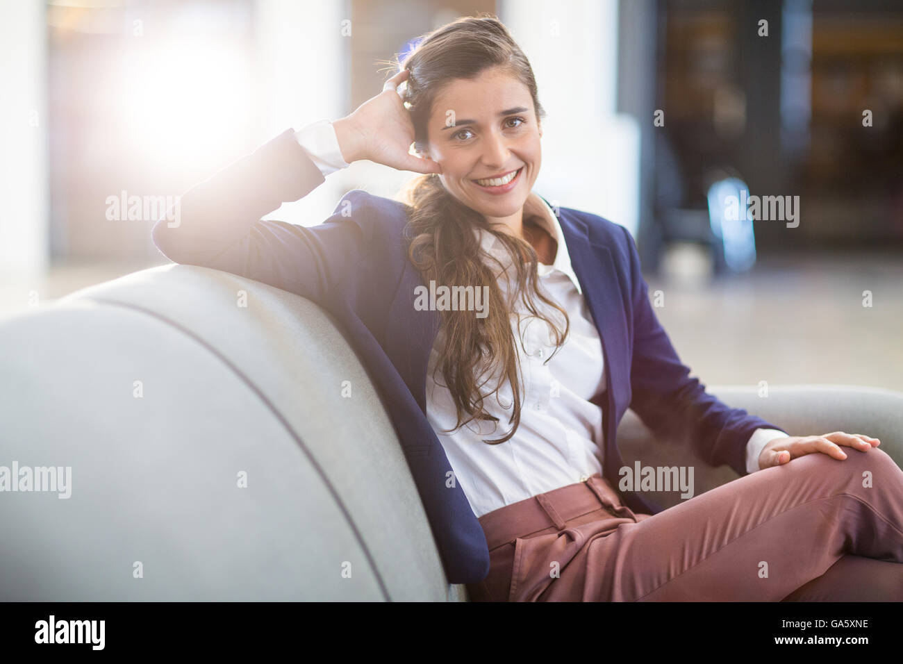 Portrait of smiling woman sitting in office Stock Photo