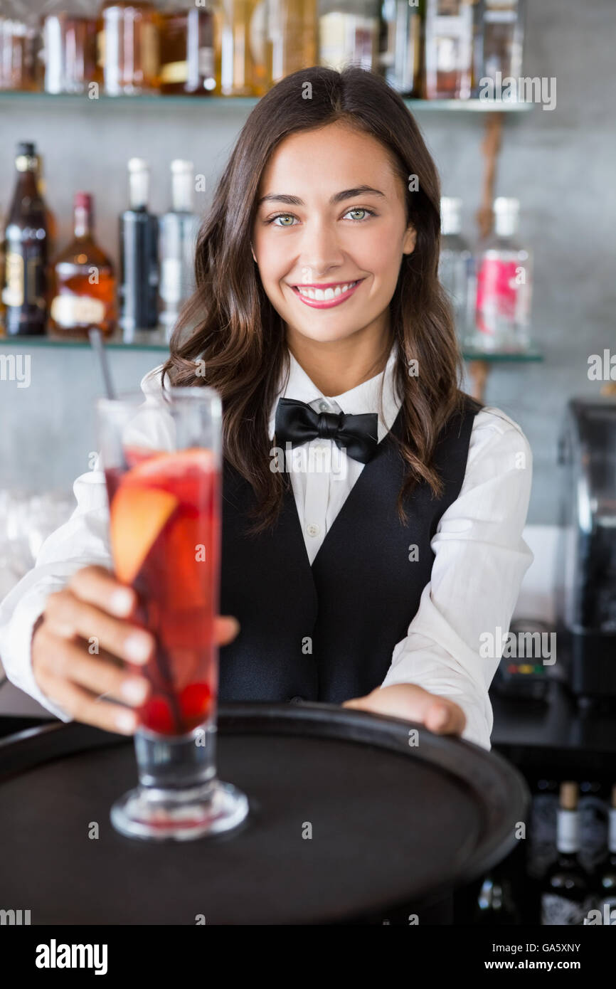 Beautiful waitress holding tray with cocktail glass Stock Photo