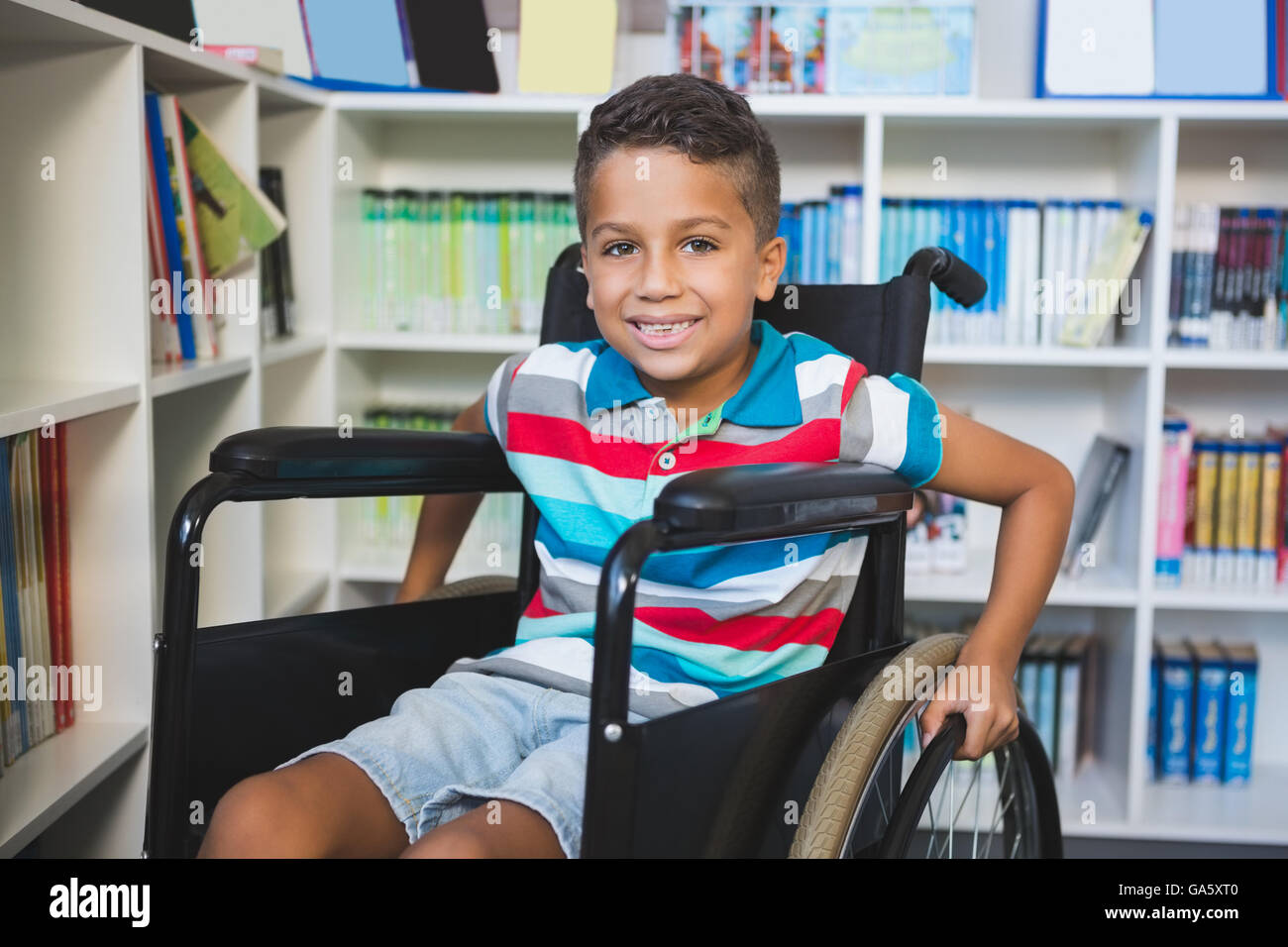 Disabled schoolboy in library Stock Photo