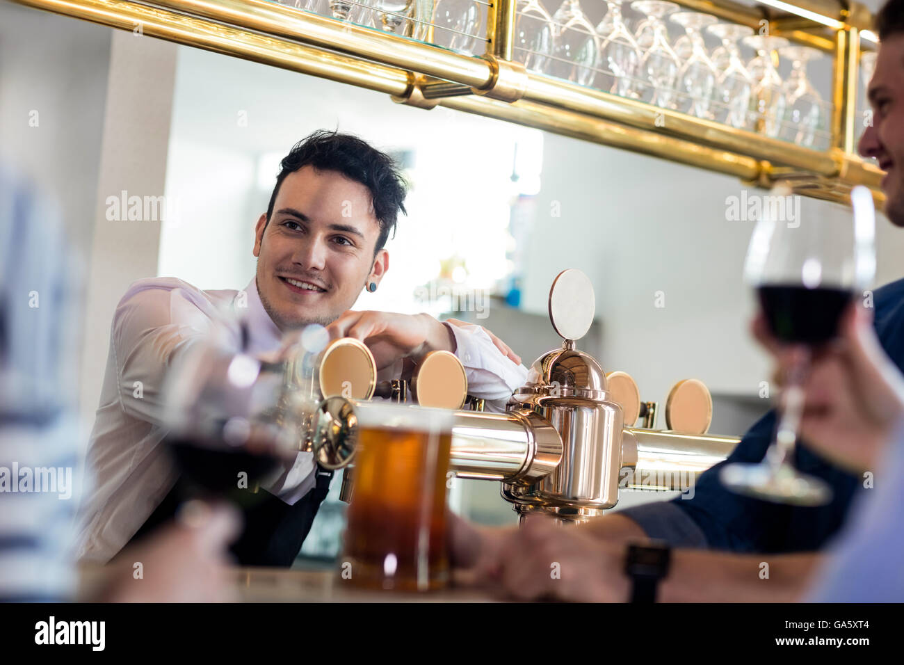 Bartender talking with customers counter Stock Photo