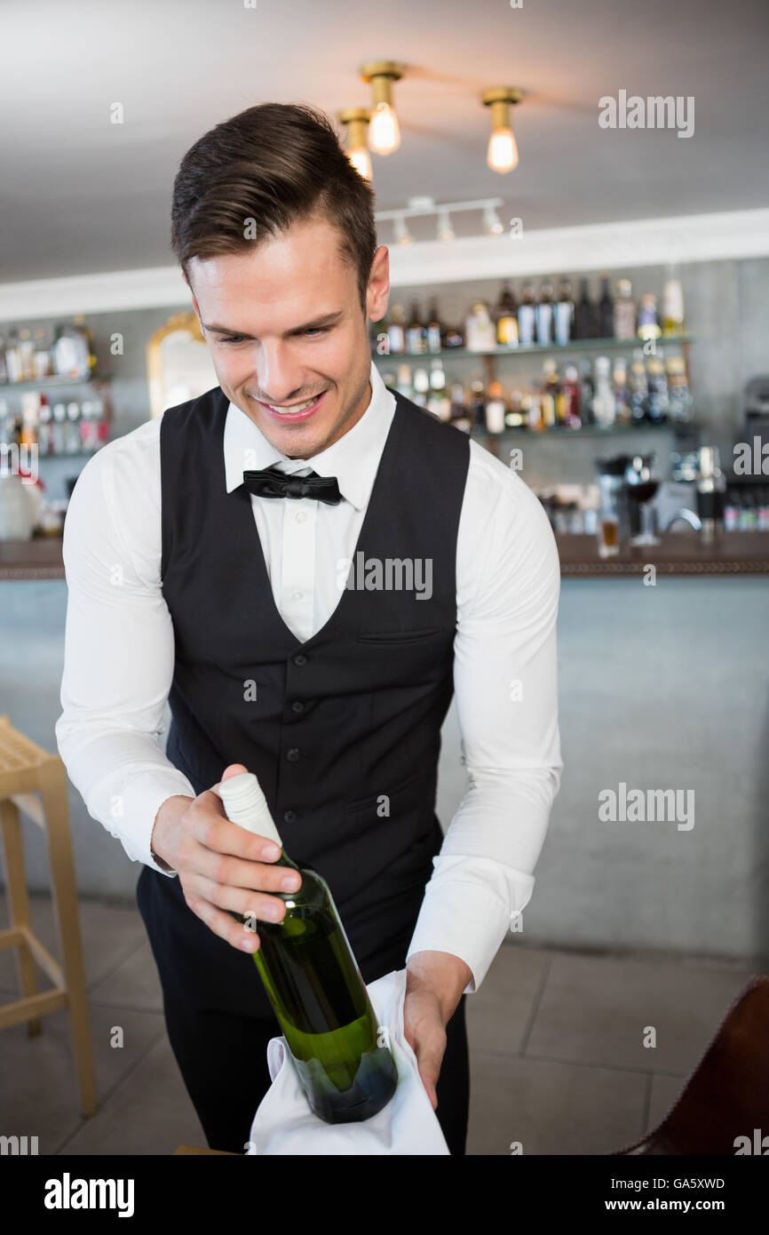 Waiter holding a bottle of wine Stock Photo