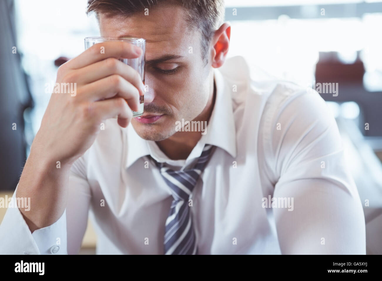 Depressed man having alcohol Stock Photo