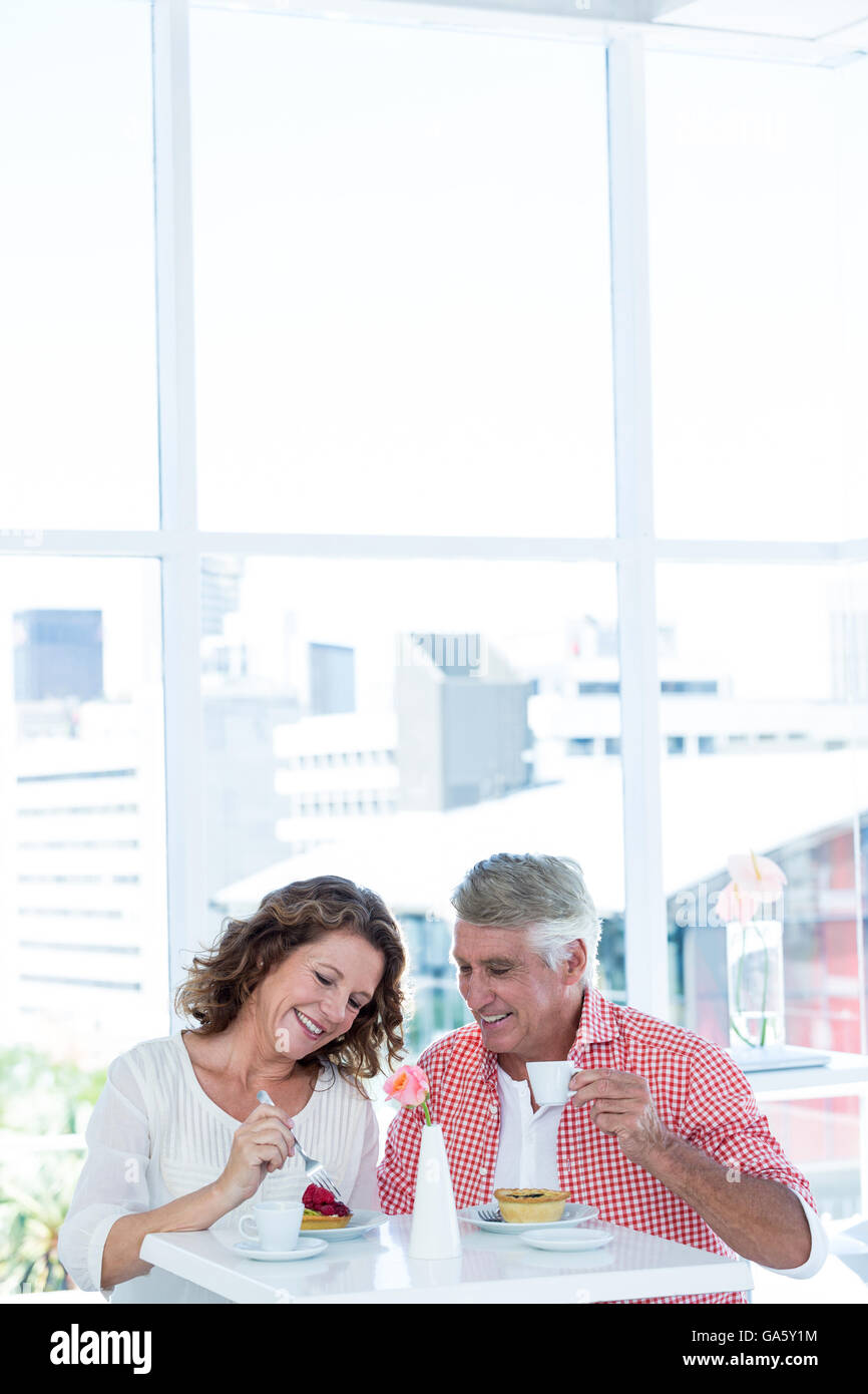 Smiling couple sitting at restaurant Stock Photo